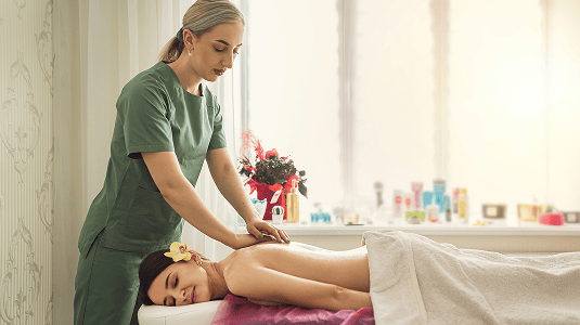 female therapist specialist makes anticellulite massage back woman client spa salon 1