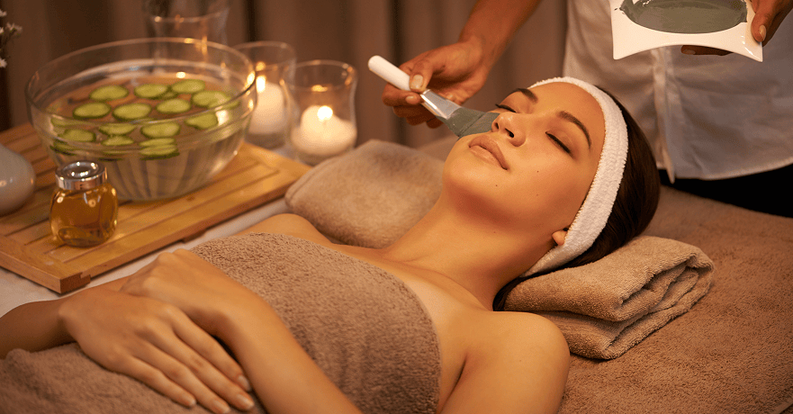 luxurious expert hands young woman lying day spa with face mask being applied 2